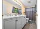 Bathroom featuring a double sink vanity, modern fixtures, and a shower with curtain at 6737 Raritan Dr, Indianapolis, IN 46221