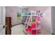 Bright bedroom featuring pink walls, a window with natural light, and a bunk bed with a Barbie doll house at 6737 Raritan Dr, Indianapolis, IN 46221