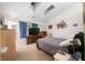 Cozy bedroom featuring a bed, dresser, and large window with natural light at 6737 Raritan Dr, Indianapolis, IN 46221