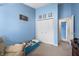 This bedroom features blue walls, a large closet, and a window with natural light at 6737 Raritan Dr, Indianapolis, IN 46221