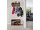 Organized entryway with a coat rack and shoe storage, leading to living area at 6737 Raritan Dr, Indianapolis, IN 46221