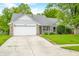 Charming single-story home with a well-manicured lawn and a welcoming porch at 6737 Raritan Dr, Indianapolis, IN 46221