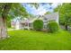 Exterior shot showcasing a home's well-kept lawn, front porch and mature trees at 6737 Raritan Dr, Indianapolis, IN 46221
