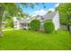 Exterior shot showcasing a home's well-kept lawn, front porch and mature trees at 6737 Raritan Dr, Indianapolis, IN 46221