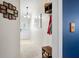 Inviting hallway with neutral tones, coat rack, decorative mirror and a collage of Gathering photos as you enter the home at 6737 Raritan Dr, Indianapolis, IN 46221