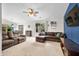 Bright living room with ample seating, natural light, and a seamless transition to the dining area creating an open feel at 6737 Raritan Dr, Indianapolis, IN 46221