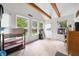 This bright sunroom features wood beams, carpeted floors, and plenty of natural light at 6737 Raritan Dr, Indianapolis, IN 46221