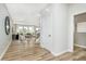 Open entryway flowing into the living room with hardwood floors and staircase at 6761 Seabiscuit Rd, Whitestown, IN 46075