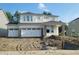 New two-story home with a three-car garage and stone accents awaiting landscaping at 6761 Seabiscuit Rd, Whitestown, IN 46075