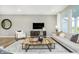 Bright living room features stylish furniture, a modern coffee table, and plenty of natural light at 6849 Seabiscuit Rd, Whitestown, IN 46075