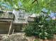 Backyard view of the home featuring a wooden deck and lots of green shrubbery at 70 Lookout Ridge Dr, Columbus, IN 47201