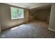 Spacious bedroom with plush carpeting and ample natural light from a large window at 70 Lookout Ridge Dr, Columbus, IN 47201