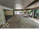Attached carport with ample space for parking and storage, leading to a garage at 70 Lookout Ridge Dr, Columbus, IN 47201
