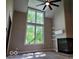 Bright living room featuring a fireplace, large windows, and custom shelving at 70 Lookout Ridge Dr, Columbus, IN 47201