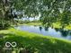 Scenic view of a tranquil pond surrounded by lush greenery and trees at 70 Lookout Ridge Dr, Columbus, IN 47201