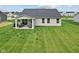 Backyard featuring a covered patio and manicured green lawn at 7051 E Bean Blossom Dr, Camby, IN 46113