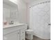 Bright bathroom with a white vanity, modern faucet, and a stylish shower curtain adding texture to the space at 7051 E Bean Blossom Dr, Camby, IN 46113