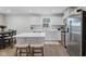 Well-designed kitchen with white cabinetry, stainless steel appliances and breakfast bar seating at 7051 E Bean Blossom Dr, Camby, IN 46113