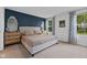 Serene main bedroom featuring neutral tones, plush bedding, and large windows at 7051 E Bean Blossom Dr, Camby, IN 46113