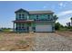 Two-story home featuring large windows and a two-car garage in the exterior elevation under construction at 71 Benfield Dr, Whiteland, IN 46184