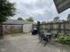 Outdoor patio space with a grill, shed and surrounded by a wooden fence at 7445 Melanie Ln, Indianapolis, IN 46217