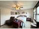 Cozy bedroom with natural light, ceiling fan and a comfortable chair near the bed at 7445 Melanie Ln, Indianapolis, IN 46217