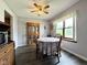 Comfortable dining area with wooden table, hutch, ceiling fan, and natural light at 7445 Melanie Ln, Indianapolis, IN 46217
