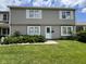 Well-maintained two-story home featuring a green lawn and tidy landscaping at 7445 Melanie Ln, Indianapolis, IN 46217
