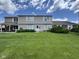 Charming two-story home with a well-manicured lawn and beautiful landscaping on a sunny day at 7445 Melanie Ln, Indianapolis, IN 46217