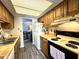 Functional kitchen featuring oak cabinets and essential appliances at 7445 Melanie Ln, Indianapolis, IN 46217