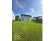 Backyard featuring a spacious green lawn and the house with light siding, perfect for entertaining at 7549 Stockard St, Indianapolis, IN 46239