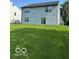 Well-maintained home backyard with a large grassy area and light siding at 7549 Stockard St, Indianapolis, IN 46239