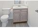 Small bathroom featuring a toilet, vanity with sink, and wood-look flooring for a compact design at 7549 Stockard St, Indianapolis, IN 46239
