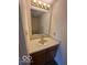 Cozy bathroom featuring a single sink vanity, neutral countertop, and classic mirror at 7549 Stockard St, Indianapolis, IN 46239