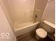 Bathroom featuring a tub with shower and standard toilet at 7549 Stockard St, Indianapolis, IN 46239