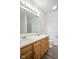 Bright bathroom featuring a double sink vanity with a shower in the background at 7549 Stockard St, Indianapolis, IN 46239