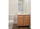 Cozy bathroom featuring a vanity with a sink, mirror, and a toilet at 7549 Stockard St, Indianapolis, IN 46239