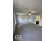 Bright bedroom with a neutral carpet, a ceiling fan, and a window that lets in natural light at 7549 Stockard St, Indianapolis, IN 46239