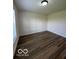 Minimalist bedroom with wood-look floors and a ceiling light at 7549 Stockard St, Indianapolis, IN 46239