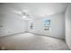 Bright bedroom with carpeted floors, two large windows, and a ceiling fan for ventilation at 7549 Stockard St, Indianapolis, IN 46239