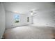 Open bedroom featuring neutral carpet, two windows and a ceiling fan with light at 7549 Stockard St, Indianapolis, IN 46239