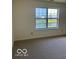 Bedroom featuring a window with a view and neutral walls and carpeted flooring at 7549 Stockard St, Indianapolis, IN 46239