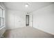 Bright bedroom featuring neutral carpeting, white walls, and multiple doors adding architectural interest at 7549 Stockard St, Indianapolis, IN 46239