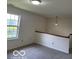 Bright bedroom featuring a large window, neutral walls, and carpeted flooring at 7549 Stockard St, Indianapolis, IN 46239