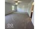 Spacious bedroom featuring carpet floors, a ceiling fan, and a sunlit window at 7549 Stockard St, Indianapolis, IN 46239