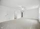 Open bedroom featuring neutral carpet and a ceiling fan with light at 7549 Stockard St, Indianapolis, IN 46239