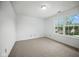 Bright bedroom with cozy carpet and a large window, providing a light-filled and comfortable atmosphere at 7549 Stockard St, Indianapolis, IN 46239