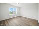 Inviting bedroom with wood-look flooring and a large window offering plenty of natural light and views at 7549 Stockard St, Indianapolis, IN 46239