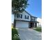 Two-story home with a two-car garage and manicured lawn at 7549 Stockard St, Indianapolis, IN 46239