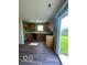 Bright kitchen featuring wooden cabinets, efficient appliances, and a sliding door to the backyard at 7549 Stockard St, Indianapolis, IN 46239